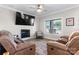 Cozy living room with a fireplace, ceiling fan, and comfortable seating arrangement at 4941 Southview Dr, Hickory, NC 28602