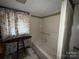 Classic bathroom with a floral shower curtain, standard tub, and tiled wall trim at 506 Waring Ct # Lot 1, Fort Mill, SC 29707