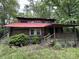 Charming log cabin exterior featuring a covered porch and a vibrant red roof at 506 Waring Ct # Lot 1, Fort Mill, SC 29707