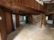 Open living room with log walls, a unique staircase, and views into adjacent rooms at 506 Waring Ct # Lot 1, Fort Mill, SC 29707
