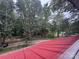 View of a bright red metal roof of a cabin surrounded by lush greenery at 506 Waring Ct # Lot 1, Fort Mill, SC 29707