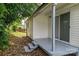 Covered back porch with steps leading to the yard, ideal for outdoor relaxation at 520 E Maple Ave, Gastonia, NC 28054