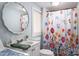 Bathroom featuring a vanity, toilet, and shower with a colorful floral shower curtain at 520 E Maple Ave, Gastonia, NC 28054