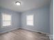 Sunlit bedroom showcasing neutral walls, large windows, and light laminate flooring at 520 E Maple Ave, Gastonia, NC 28054
