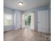 Bright bedroom featuring white trim, window, closet and door to backyard at 520 E Maple Ave, Gastonia, NC 28054