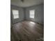 Cozy bedroom with sleek floors and dual windows providing natural light at 520 E Maple Ave, Gastonia, NC 28054
