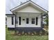 Charming home featuring a covered front porch and a freshly landscaped yard at 520 E Maple Ave, Gastonia, NC 28054