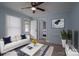Staged living room with a comfortable sofa, stylish decor, and light vinyl flooring at 520 E Maple Ave, Gastonia, NC 28054