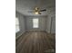 Bright living room featuring modern flooring, a ceiling fan, and ample natural light at 520 E Maple Ave, Gastonia, NC 28054