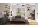 Comfortable bedroom with a large window, reading chair, and hardwood floors at 528 Beatties Ford Rd, Charlotte, NC 28216