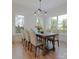 Bright dining room features wood floors, a table set for six, and natural light at 528 Beatties Ford Rd, Charlotte, NC 28216