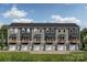 New townhome construction features individual garages and covered patios at 528 Beatties Ford Rd, Charlotte, NC 28216