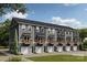 New townhome construction features individual garages, balconies, and neutral color palette at 528 Beatties Ford Rd, Charlotte, NC 28216