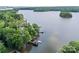 Scenic aerial view of a lakefront property with mature trees and a private dock at 570 Blue Heron Rd, Salisbury, NC 28146