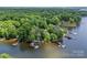 Aerial shot of lake houses, docks, and lush forests along the shoreline at 570 Blue Heron Rd, Salisbury, NC 28146