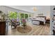 Bedroom with large windows, balcony access, a seating area, and a king-sized bed at 570 Blue Heron Rd, Salisbury, NC 28146