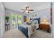 Comfortable bedroom with a queen-size bed, ceiling fan, and view of the garden at 570 Blue Heron Rd, Salisbury, NC 28146