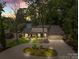 Stunning lakefront home with lush landscaping, inviting entrance, and charming stone and siding exterior at 570 Blue Heron Rd, Salisbury, NC 28146