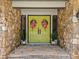 Close-up of the front door with colorful wreaths and stone accents at 570 Blue Heron Rd, Salisbury, NC 28146