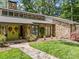 Charming stone home with a well-manicured lawn, stone pathway, and colorful wreaths adorning the front doors at 570 Blue Heron Rd, Salisbury, NC 28146