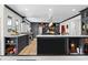 Modern kitchen with dark cabinetry, stainless steel appliances, and a large center island at 570 Blue Heron Rd, Salisbury, NC 28146