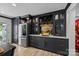 Modern kitchen with sleek black cabinetry, stainless steel refrigerator, and beverage center at 570 Blue Heron Rd, Salisbury, NC 28146
