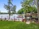 Charming lakeside area with a sandy beach, swing, and picturesque views of the water at 570 Blue Heron Rd, Salisbury, NC 28146
