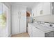 Functional laundry room with ample storage cabinets and modern washer and dryer units at 570 Blue Heron Rd, Salisbury, NC 28146