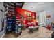 Eclectic living room featuring spiral staircase, bright red accent wall, and quirky decor at 570 Blue Heron Rd, Salisbury, NC 28146