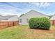 Backyard featuring a manicured privacy hedge and fenced perimeter, ideal for outdoor entertaining at 5804 Fairchase Ave, Charlotte, NC 28269