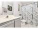 Cozy bathroom features a gray vanity and a shower with a marble-patterned curtain at 5804 Fairchase Ave, Charlotte, NC 28269