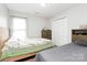 Bright bedroom with two beds, a window, closet and a dresser at 5804 Fairchase Ave, Charlotte, NC 28269