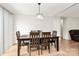 Bright dining area featuring a wooden table, seating for six, and a contemporary chandelier at 5804 Fairchase Ave, Charlotte, NC 28269