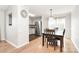 Bright dining area with hardwood floors, a modern light fixture, and an open view to the kitchen at 5804 Fairchase Ave, Charlotte, NC 28269