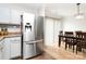 Bright dining area featuring stainless steel refrigerator, dining table set, and wood floors at 5804 Fairchase Ave, Charlotte, NC 28269