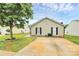 Inviting single-story home featuring a charming exterior and paved driveway at 5804 Fairchase Ave, Charlotte, NC 28269