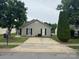 A charming single-story home featuring a concrete driveway and neutral siding with black shutters at 5804 Fairchase Ave, Charlotte, NC 28269