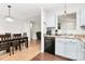 Bright kitchen featuring stainless steel appliances, light wood floors, and an adjacent dining area at 5804 Fairchase Ave, Charlotte, NC 28269