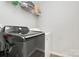 Laundry room with a dark gray front load washing machine and a white dryer at 5804 Fairchase Ave, Charlotte, NC 28269