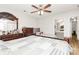 Large main bedroom with hardwood floors, a ceiling fan, and an ensuite bathroom at 5804 Fairchase Ave, Charlotte, NC 28269