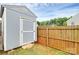 Close-up of shed in backyard surrounded by fencing and grass at 5804 Fairchase Ave, Charlotte, NC 28269