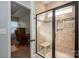 Tiled shower with glass door and bench in primary bathroom at 5849 Mcclintock Dr # 117, Denver, NC 28037