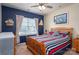 Bedroom with blue accent wall, nautical decor and a large window at 5849 Mcclintock Dr # 117, Denver, NC 28037