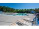 Large community pool with lounge chairs, a lifeguard stand, and a slide at 5849 Mcclintock Dr # 117, Denver, NC 28037