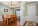 Dining room with hardwood floors, decorative trim, chandelier, and entry door at 5849 Mcclintock Dr # 117, Denver, NC 28037