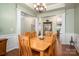 Dining room featuring hardwood floors, detailed trim, and stylish chandelier at 5849 Mcclintock Dr # 117, Denver, NC 28037