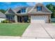 Charming home with a lush green lawn, stone accents, and a spacious two-car garage at 5849 Mcclintock Dr # 117, Denver, NC 28037