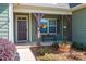 Inviting front porch featuring a bench, hanging plants, and attractive landscaping at 5849 Mcclintock Dr # 117, Denver, NC 28037
