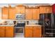 Kitchen featuring wood cabinets, stainless steel appliances, granite countertops and decor at 5849 Mcclintock Dr # 117, Denver, NC 28037