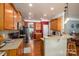 Eat-in kitchen featuring granite countertops, wood cabinets, stainless steel appliances and wood flooring at 5849 Mcclintock Dr # 117, Denver, NC 28037